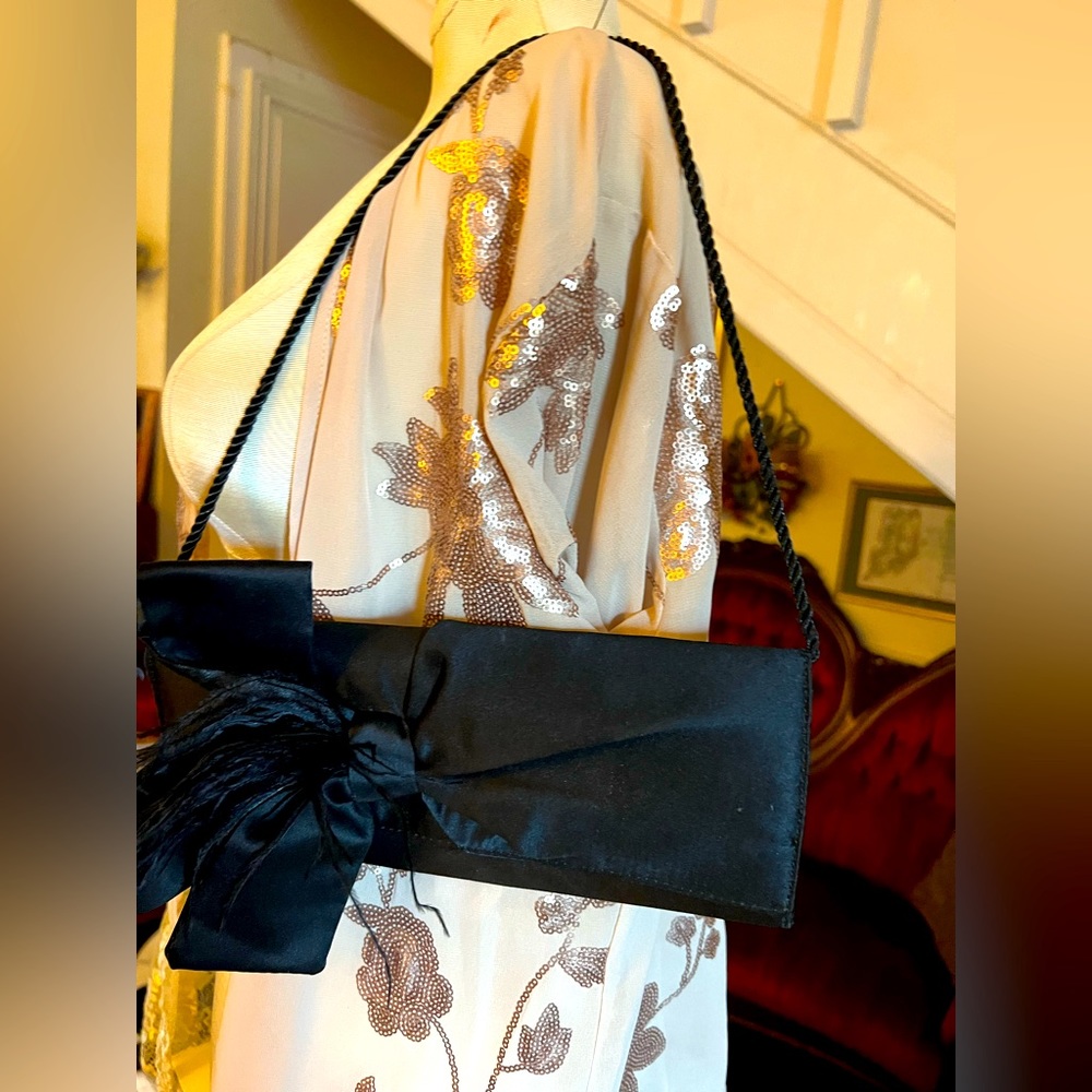 Cute little bag for formal occasions. Satin accented with a large fancy bow
